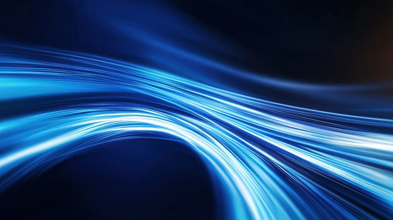 Abstract image of bright blue light rays forming a dynamic, curving wave against a dark background, representing high-speed data flow and optical transmission.
